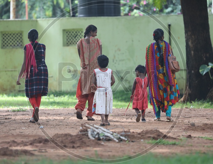 Indian kids walking with their mothers