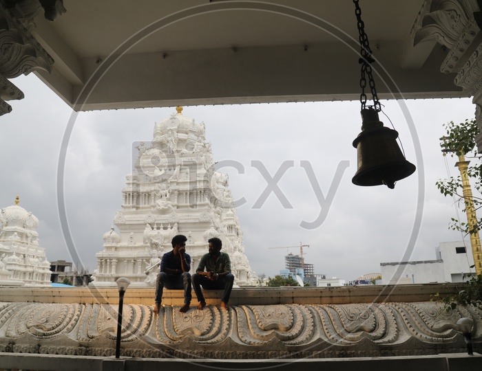 Two men having a conversation in a temple