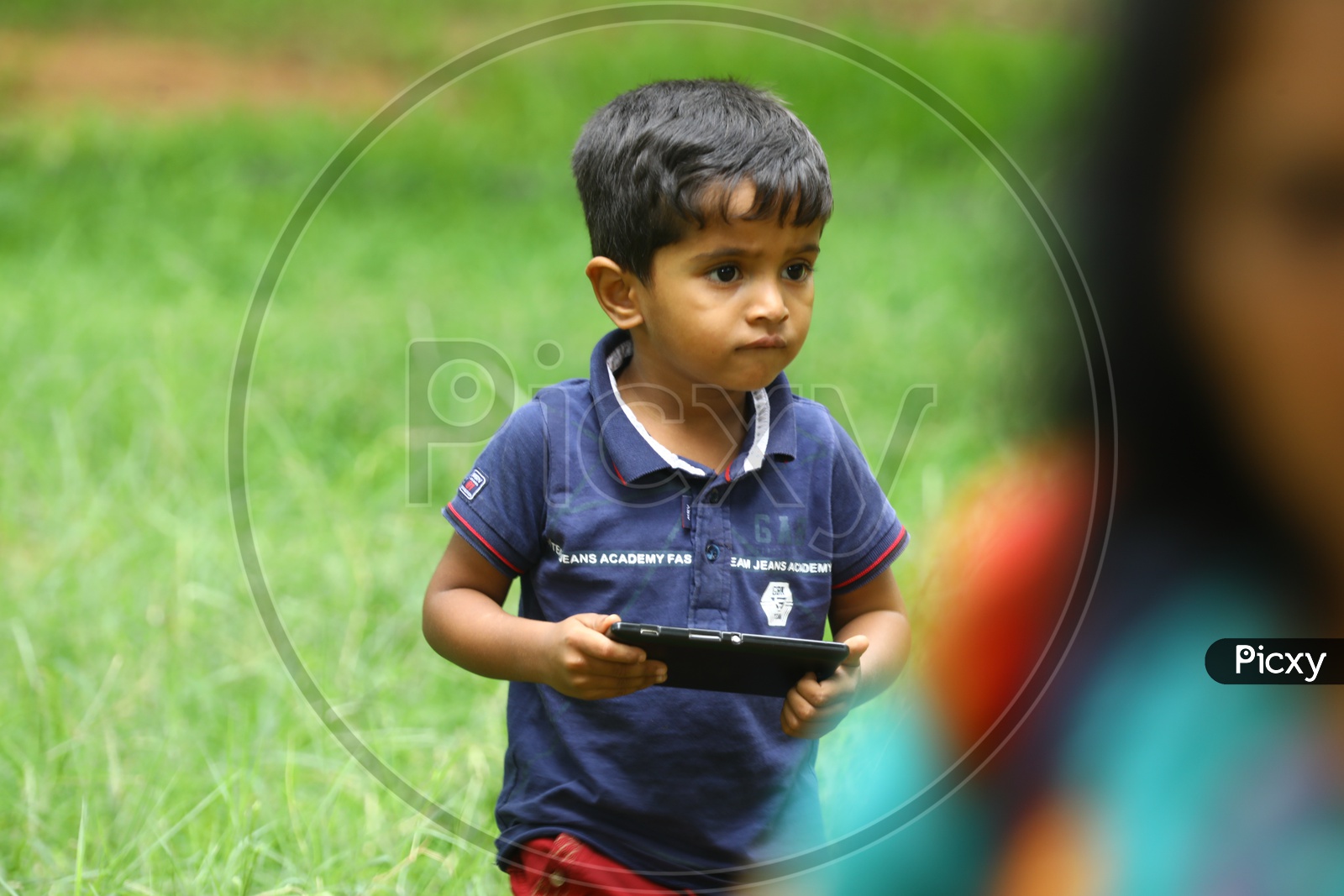 A little boy holding a mobile phone