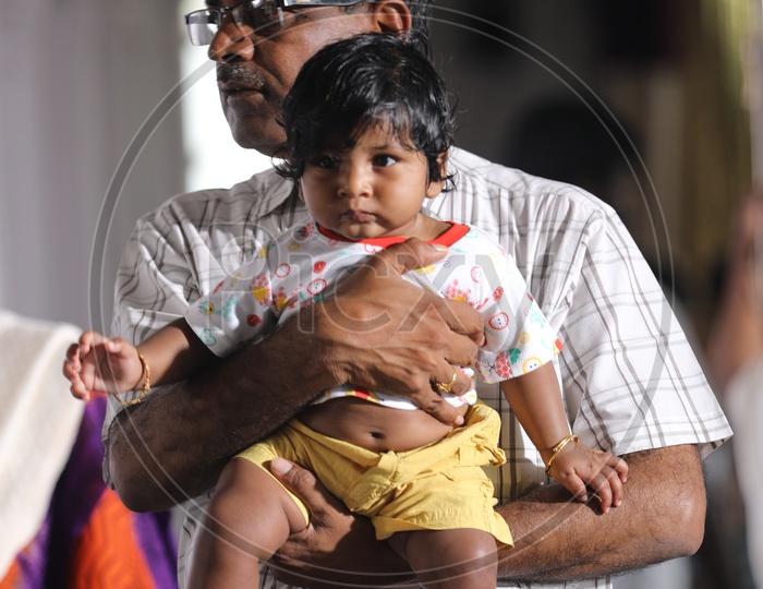 Indian grand Father with his Child in a temple