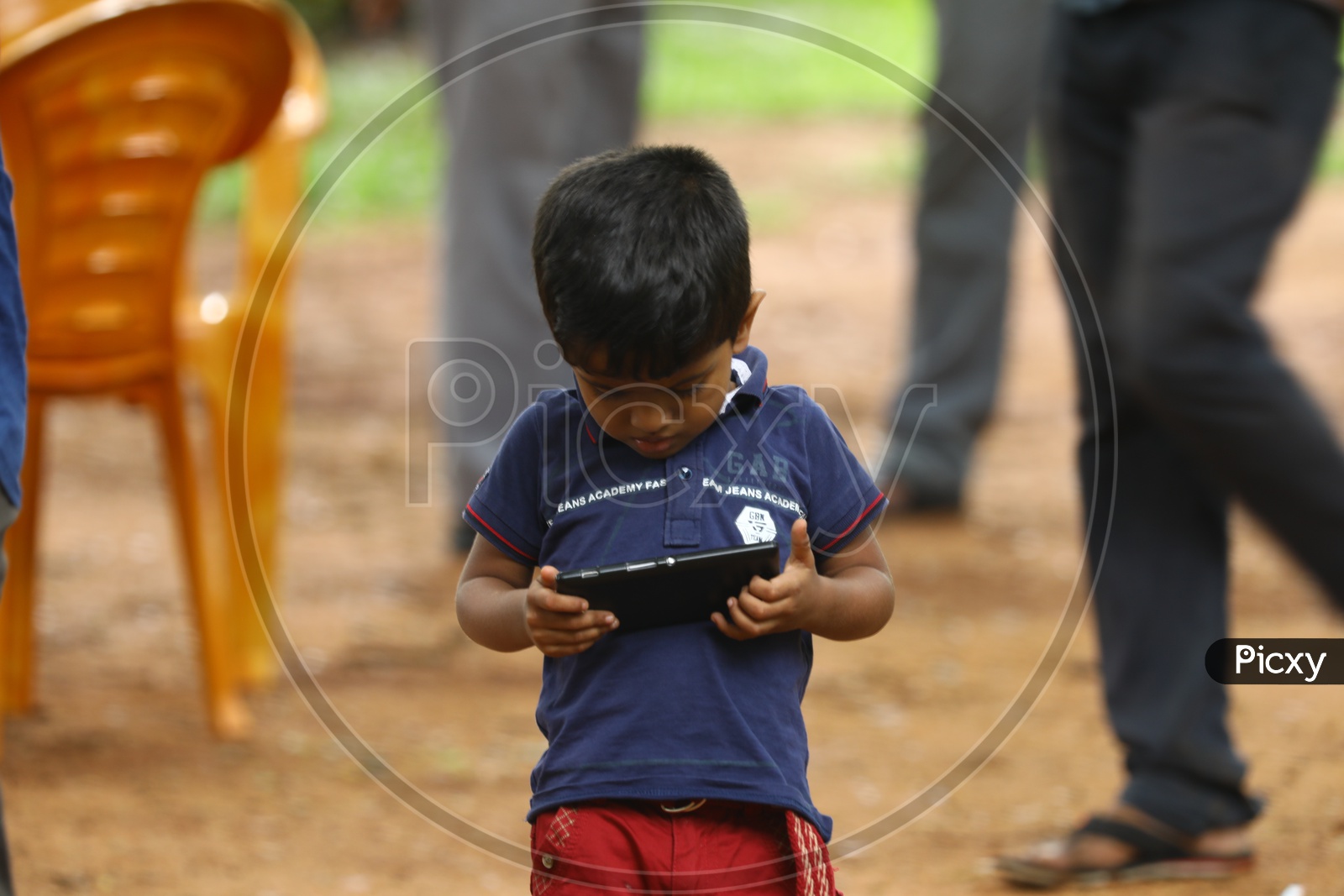 An Indian little boy using a smartphone