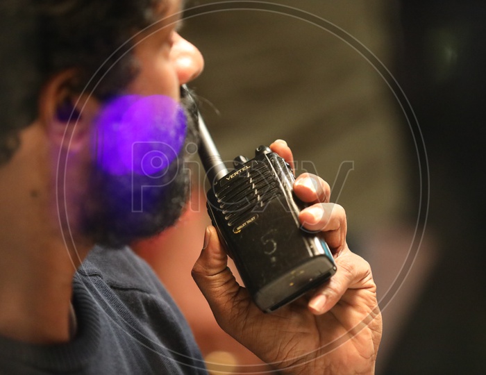 Indian man communicating over Walkie Talkie