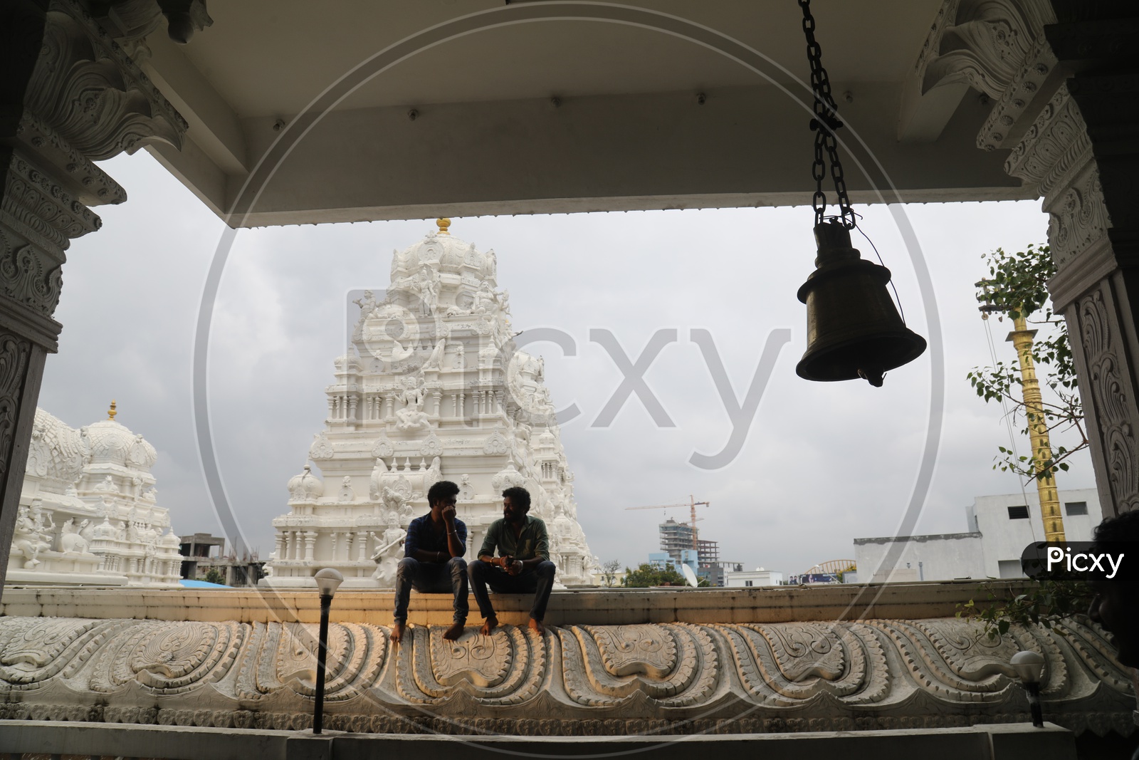 Two men having a conversation in a temple