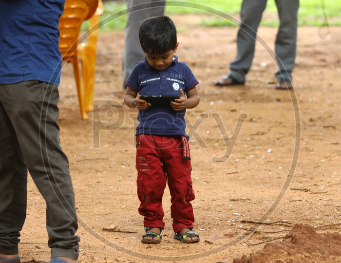 An Indian boy playing games in smartphone