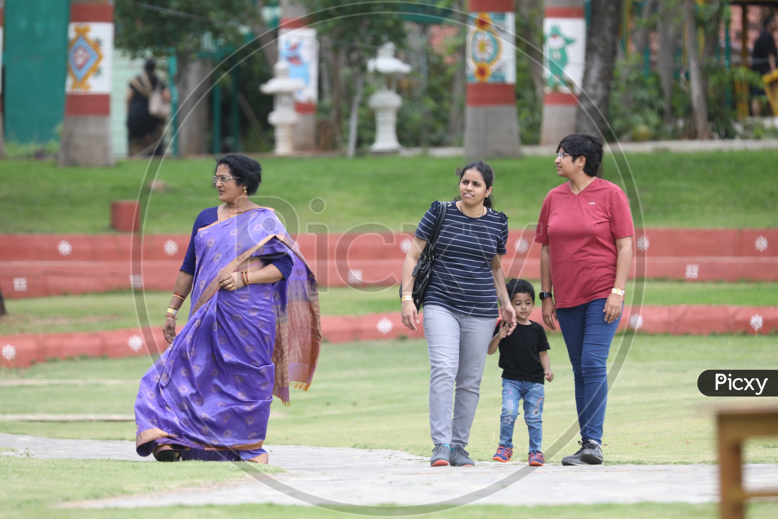 Woman  And Mother With Child Walking in  Lawn Of a Park