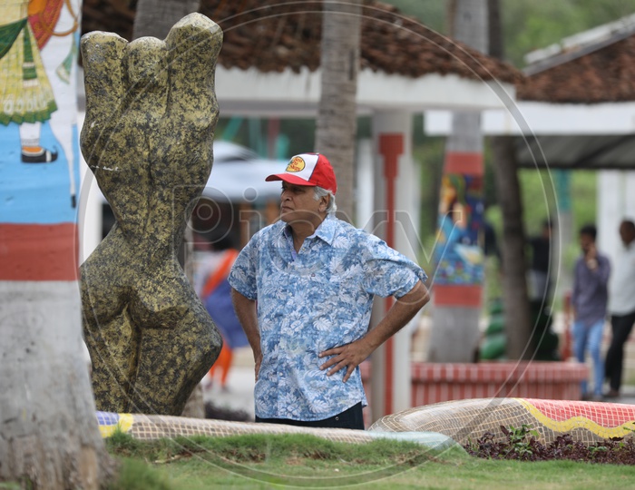 An old Man Wearing Red Cap in a Park