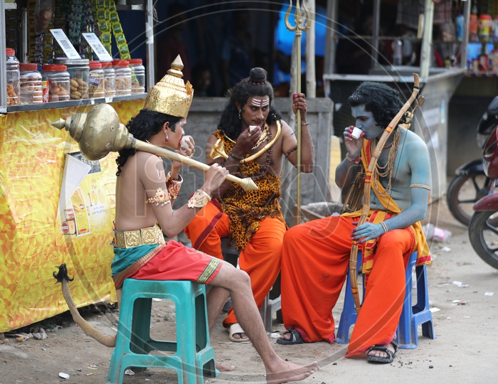 Man in Indian  Mythology  Gods  Makeup Having Tea at a tea Stall
