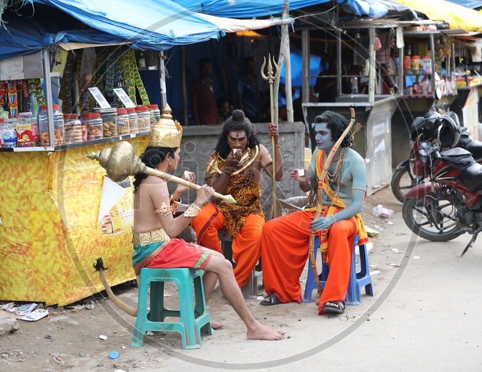 Man in Indian  Mythology  Gods  Makeup Having Tea By Sitting at a Road Side  tea Stall