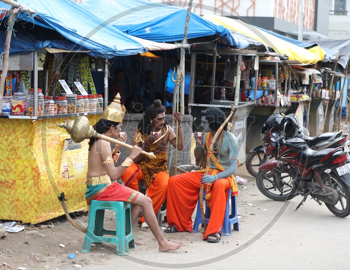 Indian Artists in Hindu God Dresses Sitting and Having Tea at a Road side Tea Stall