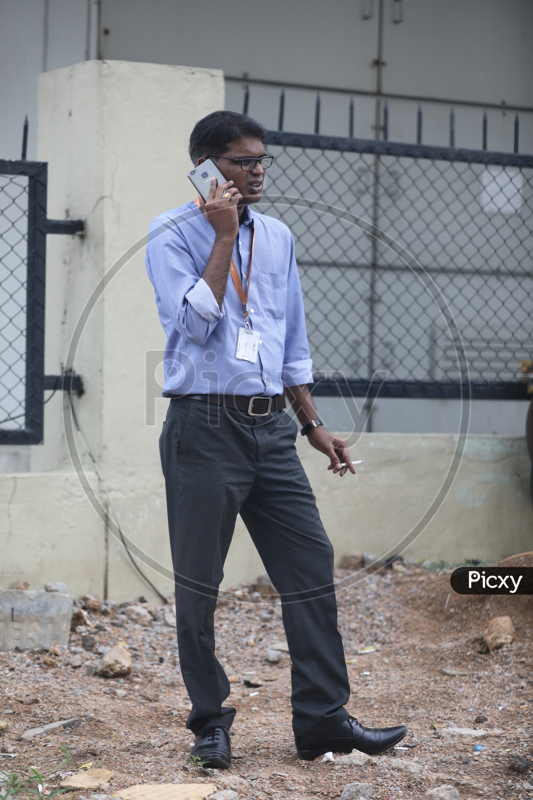 IT Employee Smoking Cigarette While Speaking in Mobile Phone