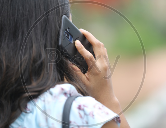 Young Indian Woman talking on Mobile or Smartphone