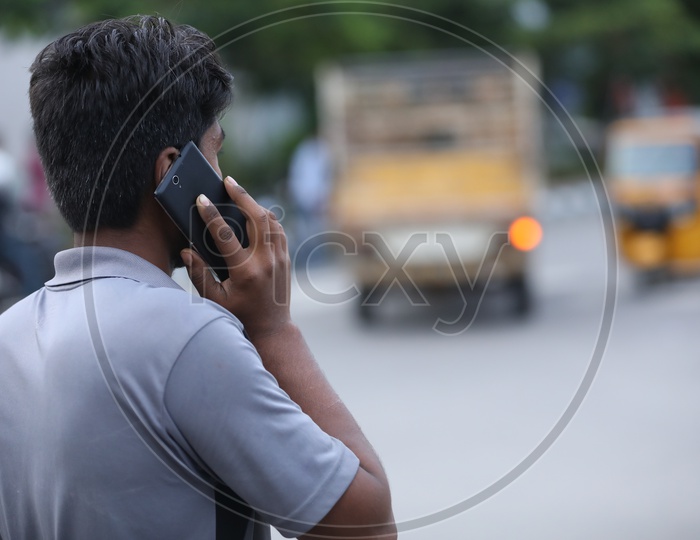 Man Speaking In Mobile Phone on a Road