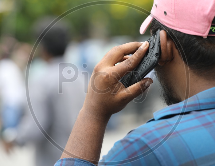 Indian Man talking on Mobile or Smartphone