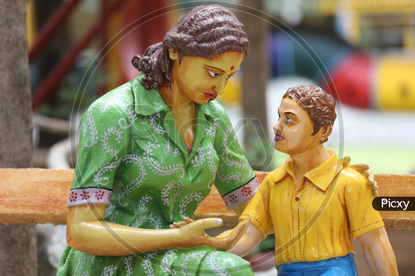 Closeup Of Statue Of a Mother and Son In a Park
