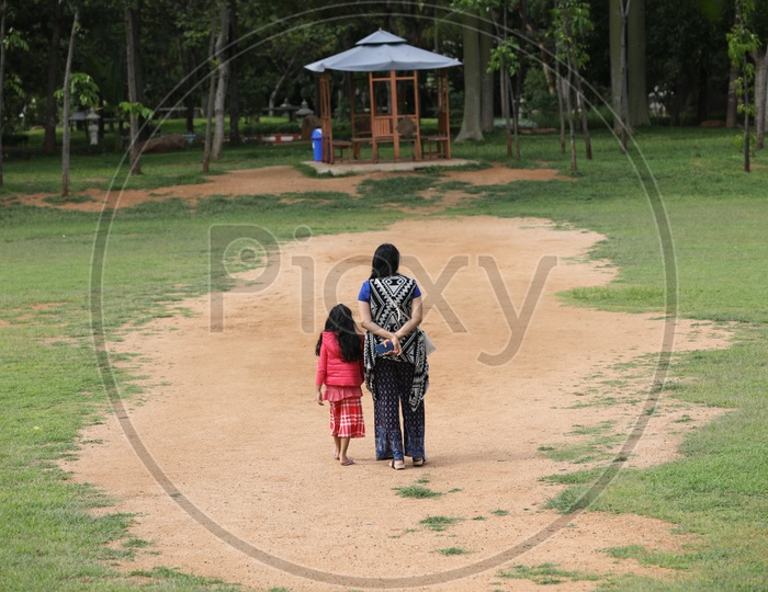 Young Indian Mother Walking with Her daughter