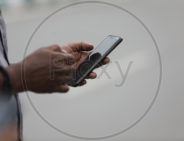 Indian Man using Mobile or Smartphone