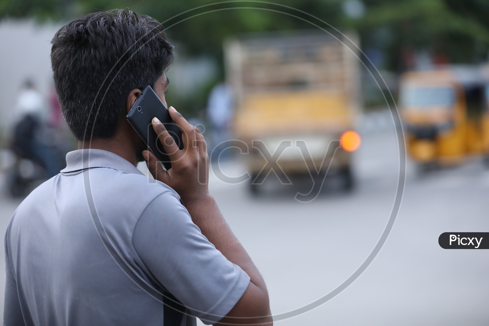 Man Speaking In Mobile Phone on a Road