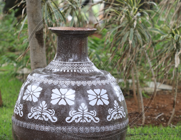 a Big Pot With Design In a Lawn Of a Park