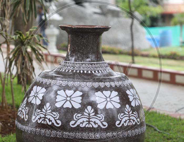 a Big Pot With Design In a Lawn Of a Park
