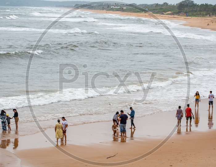 People enjoying at Sinquerium Beach Goa, Candolim, Goa, India
