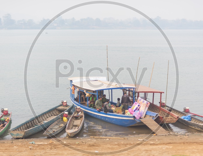 Unidentified people in a boat for crossing the border of Thailand and Laos at Ubon Ratchathani province in Thailand
