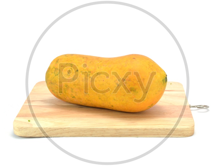 A papaya on cutting board