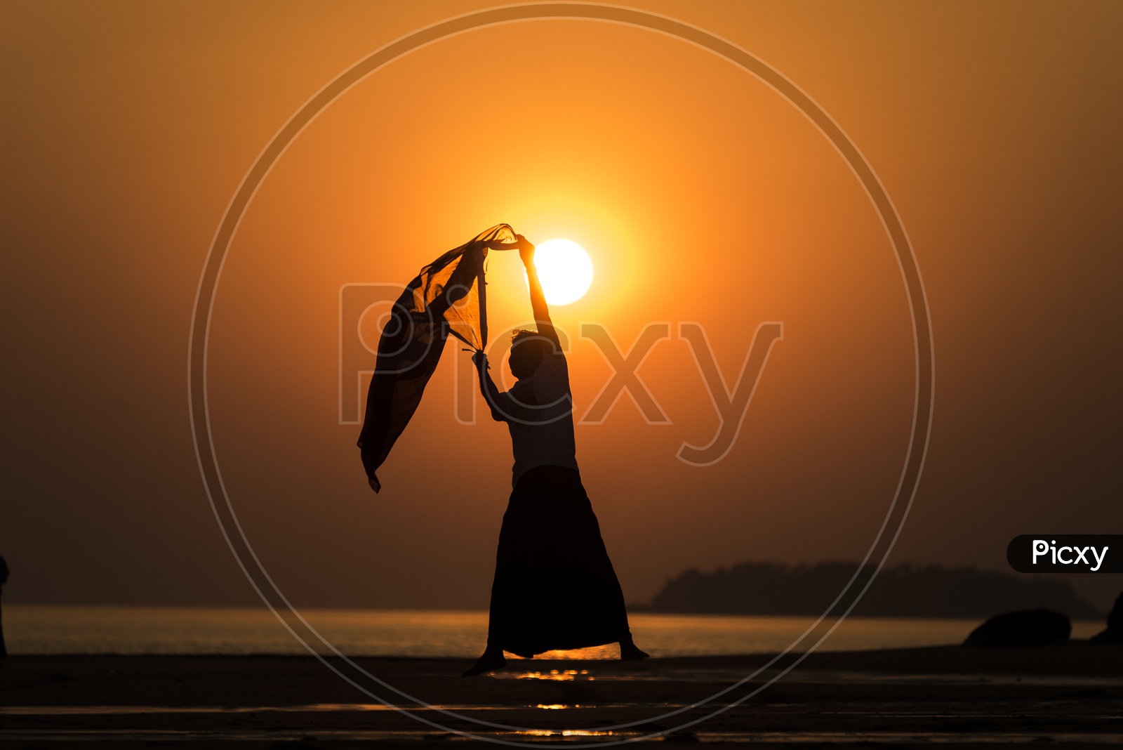 Silhouette of a man dancing with Scarf during sunset in Thailand