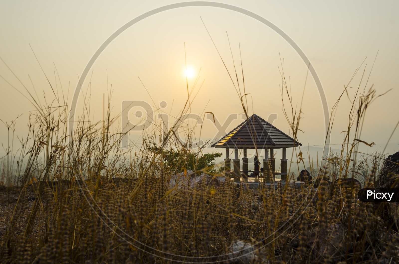 Sunset Over A Hill top With Pavilion