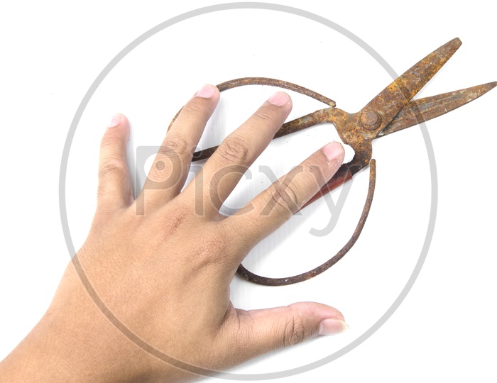 A Man holding rusted scissors
