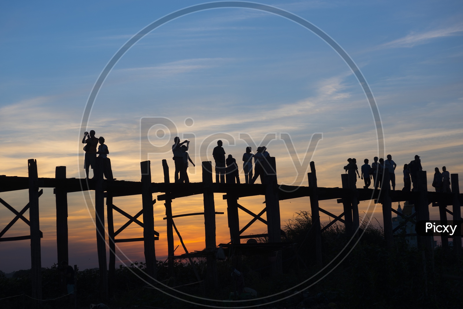Tourists taking pictures on U Bein Bridge during sunset in Amarapura, Myanmar Burma