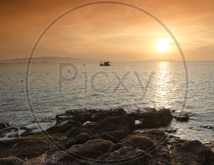 Sunrise over the sea and fishing boat in Hua Hin, Thailand