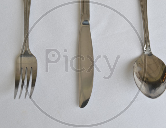 Fork, Spoon And Knife On a Restaurant Dining Table