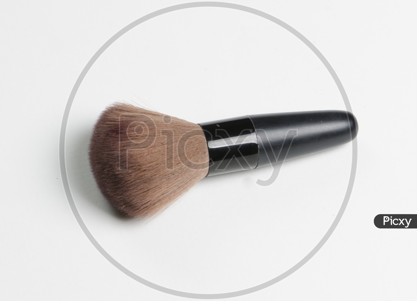 A brown thick makeup brush