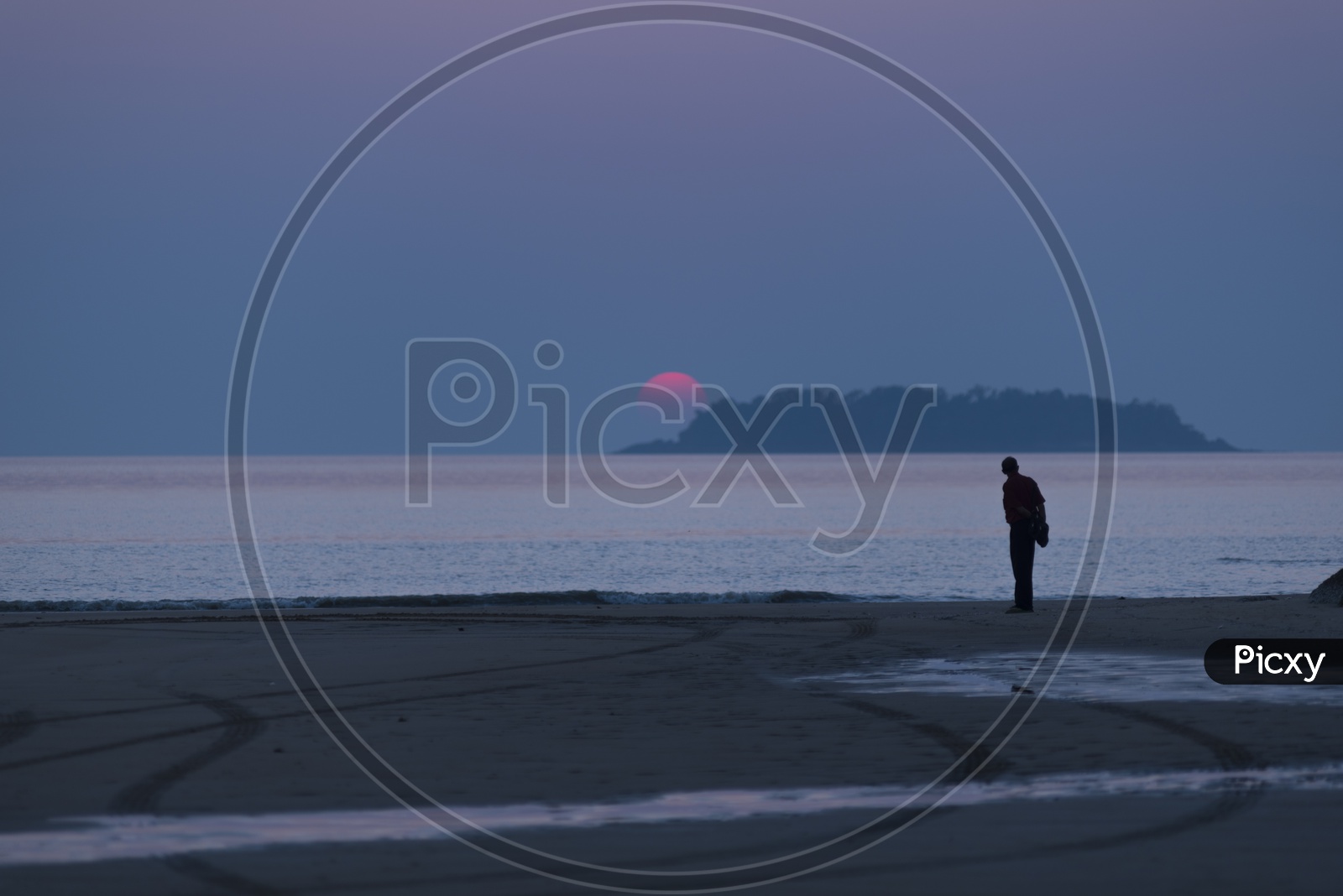 A Lonely man by the Thailand beach during sunset