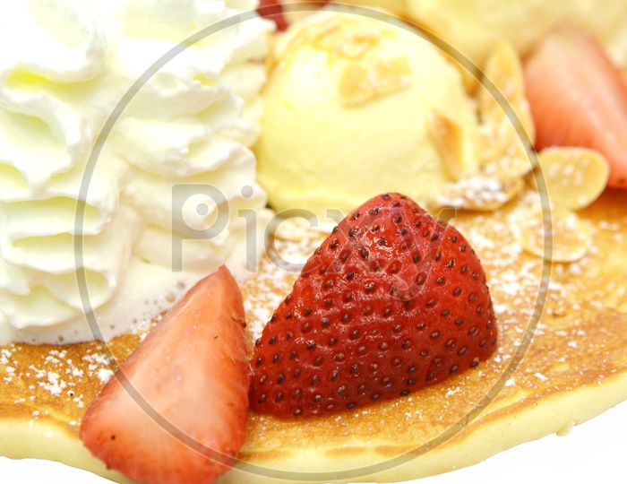Pan Cake Served With Strawberry And Ice cream