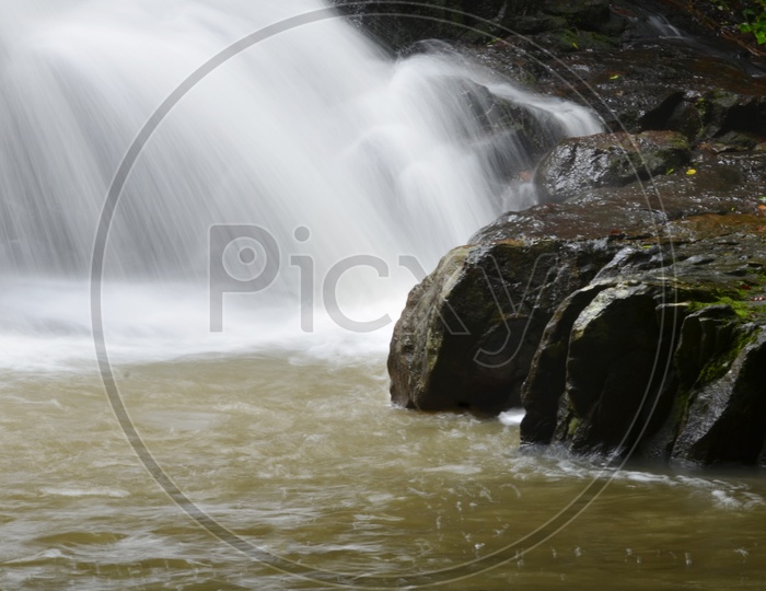 Smooth And Silky  Texture Of Water Flowing Over Stones At Erawan Water falls