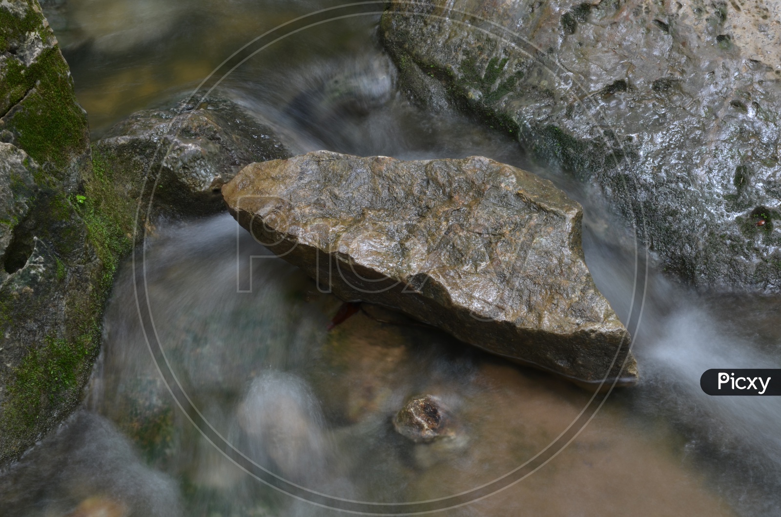 Water Stream Flowing Over Stones With Smooth Silky Texture