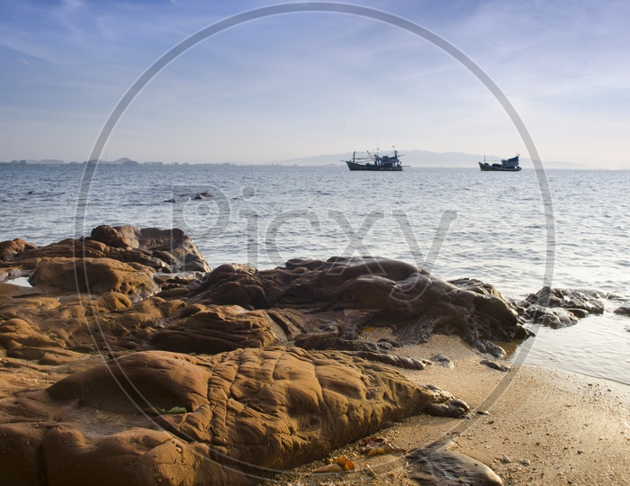 Rock Beach  and fishing boat in countryside of Hua Hin , Thailand