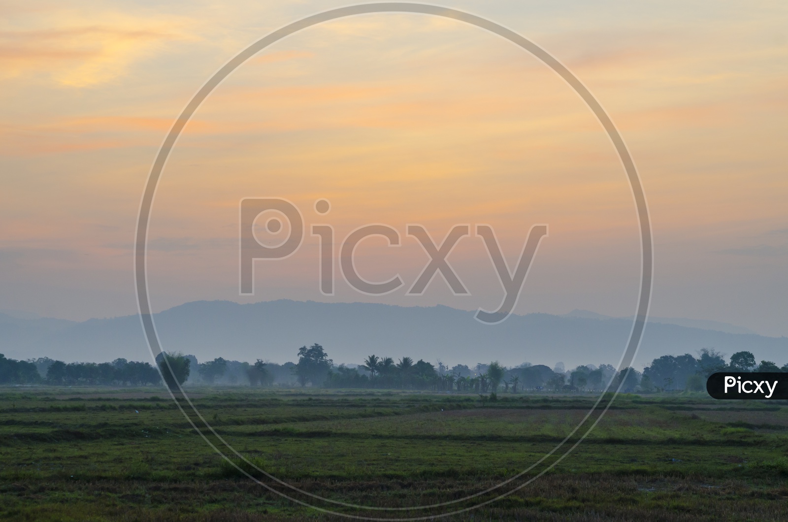 Sunset / sunrise Over Mountains With Agricultural Fields In Foreground