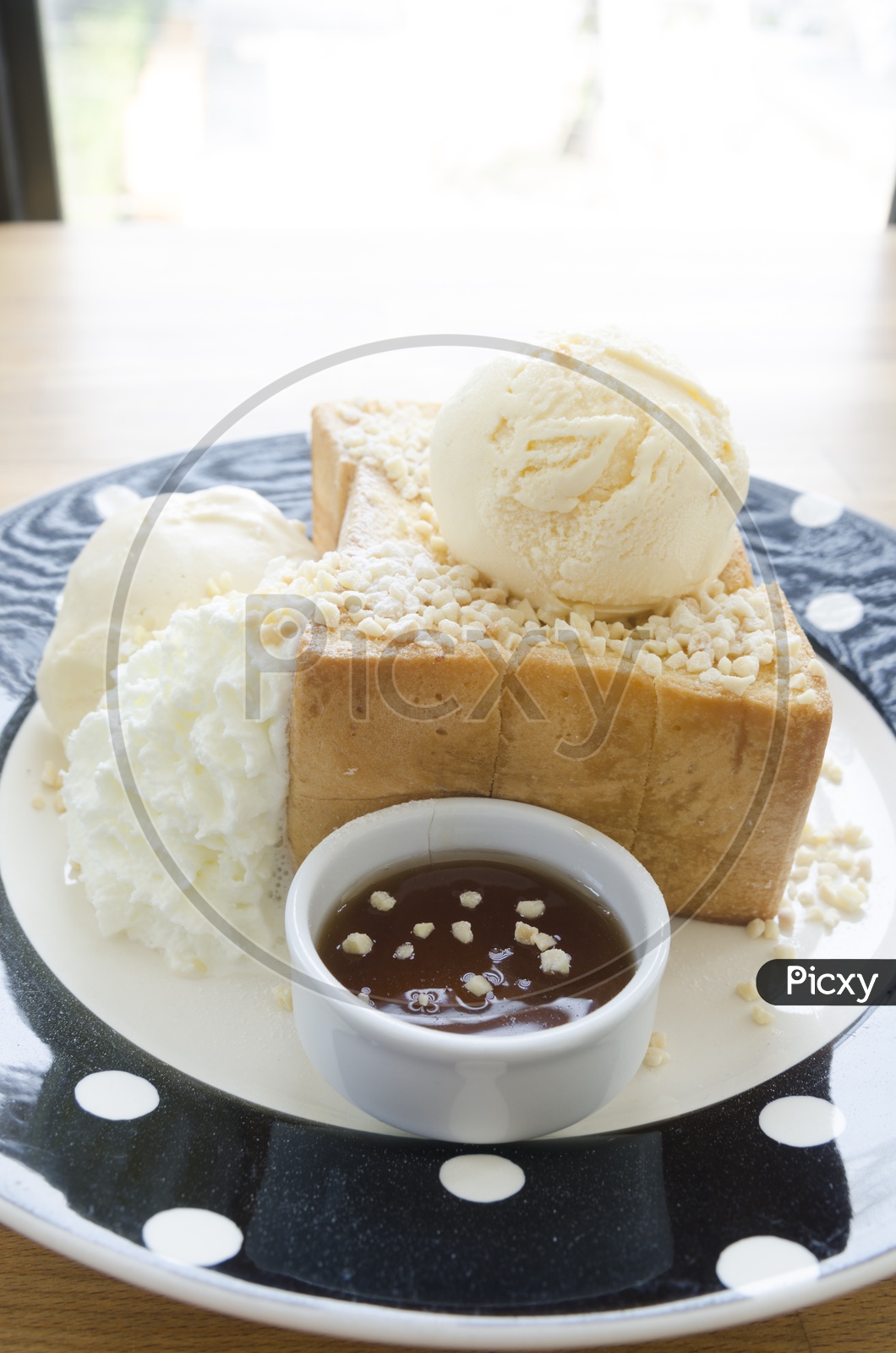 Honey Toast bread topped with honey and ice cream in a Plate