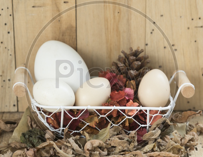 Easter eggs in a basket with wood background