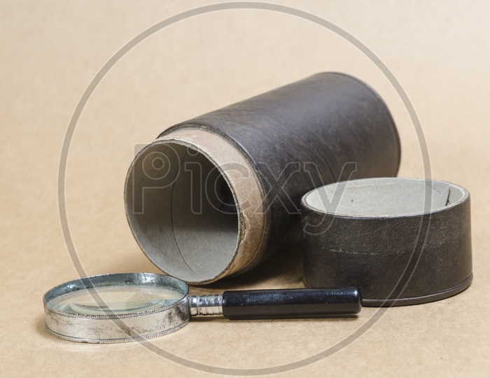 Magnifier and old items on Wooden Background