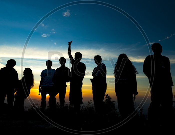 Silhouette of a group of people or Team Members at sunset