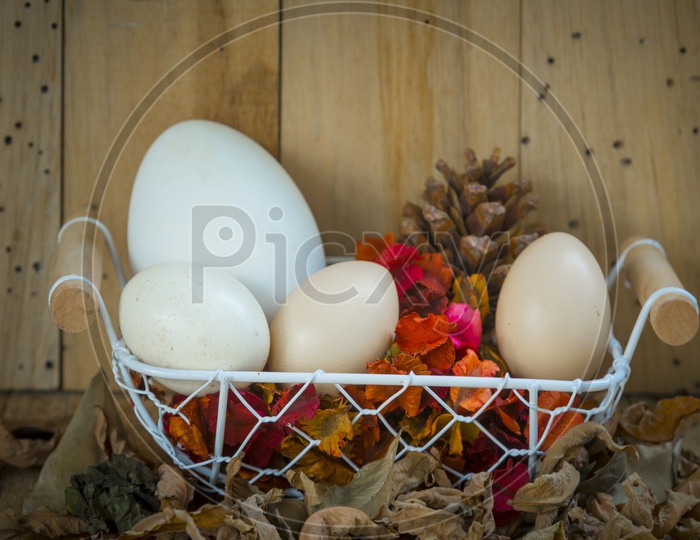 Easter Eggs in a basket with wooden background