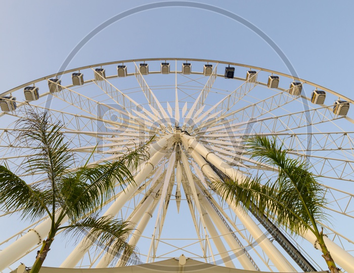 A Large Ferris wheel in the blue sky of Thailand