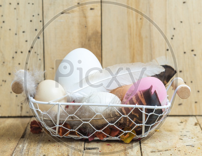 easter eggs in a basket with wood background
