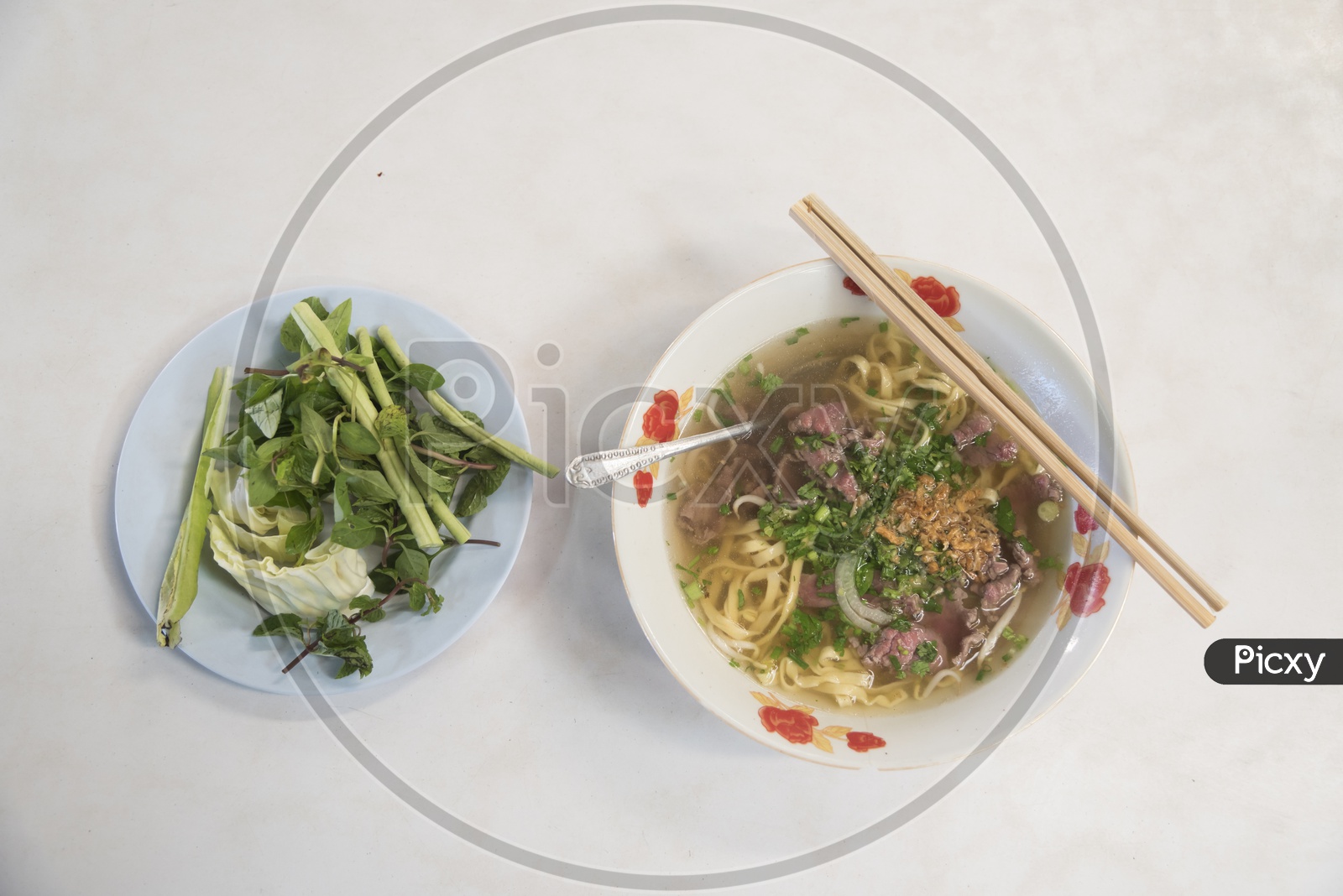 Pho Bo - Vietnamese fresh rice noodle soup with beef, herbs and chili