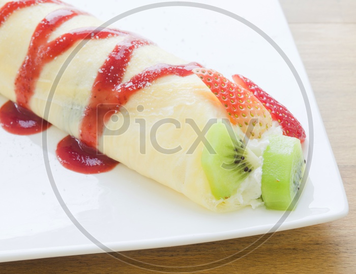 Crepes With Berries and kiwi. Crepe with Strawberry, Raspberry, Blueberry and Chocolate topping. Pancake