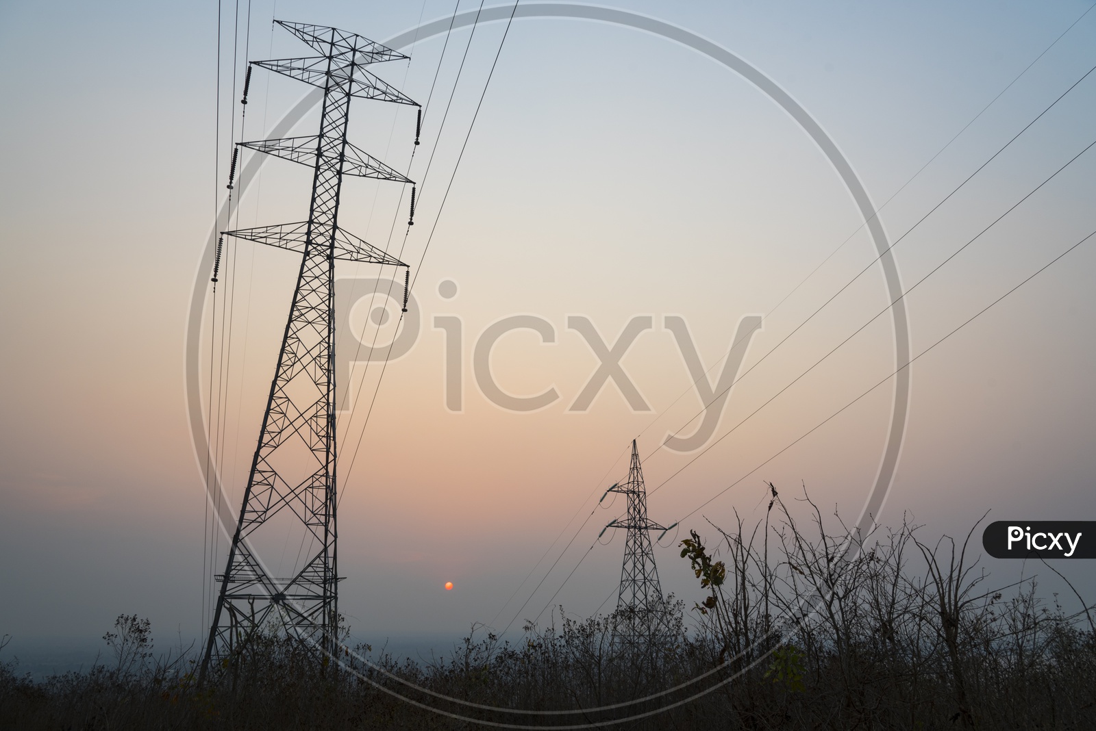 Hi tension Thailand transmission towers during sunset
