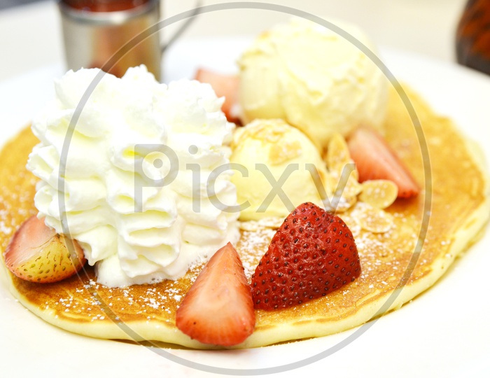 Pan Cake Served With Strawberry And Ice cream
